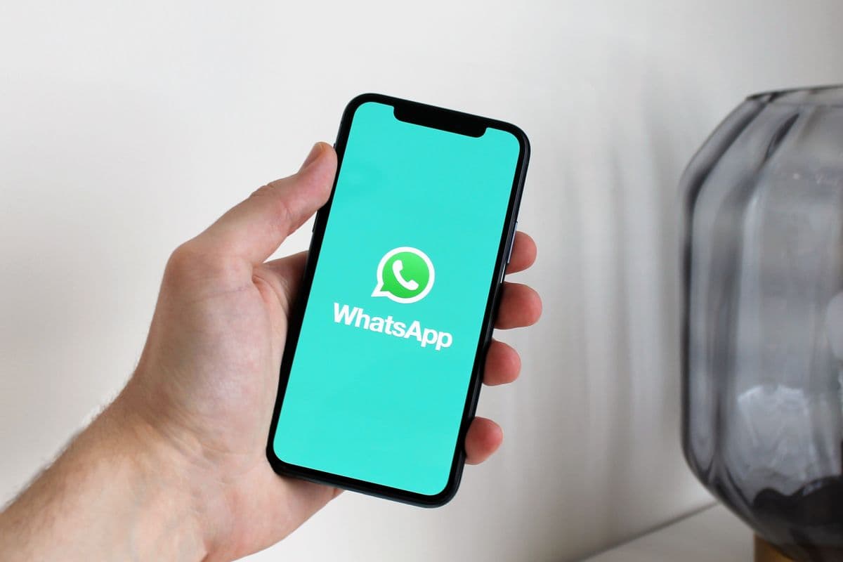 Bir masada duran telefon ekranında mesajlaşma uygulaması açık